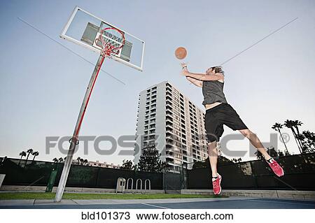 Caucasian man playing basketball outdoors View Large Photo Image Stock Image - Caucasian man playing basketball outdoors. Fotosearch