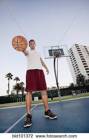 Caucasian man standing on basketball court View Large Photo Image Stock Image - Caucasian man standing on basketball court. Fotosearch
