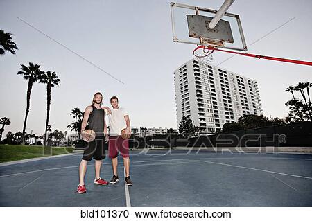 Caucasian men standing on basketball court View Large Photo Image Stock Image - Caucasian men standing on basketball court. Fotosearch
