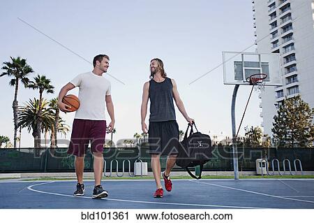 Caucasian men walking on basketball court View Large Photo Image Stock Image - Caucasian men walking on basketball court. Fotosearch