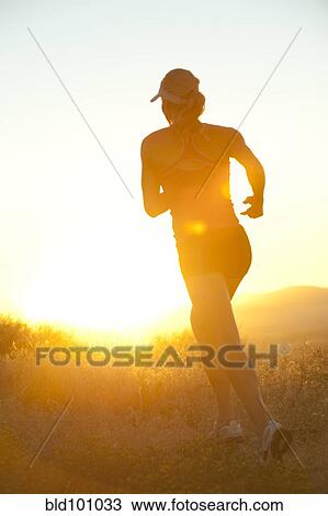 Caucasian woman running at sunset View Large Photo Image Stock Image - Caucasian woman running at sunset. Fotosearch