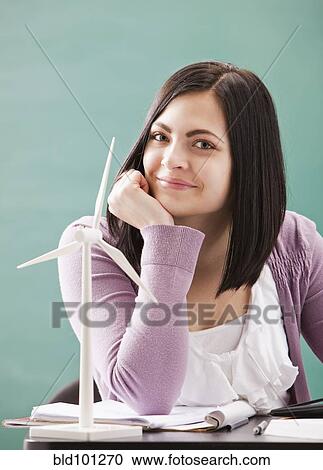 Caucasian woman sitting with wind turbine model View Large Photo Image Stock Image - Caucasian woman sitting with wind turbine model. Fotosearch