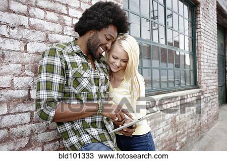 Stock Image - Couple using digital tablet. Fotosearch