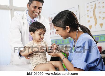 Doctor and nurse examining baby in doctor's office View Large Photo Image Stock Image - Doctor and nurse examining baby in doctor's office. Fotosearch