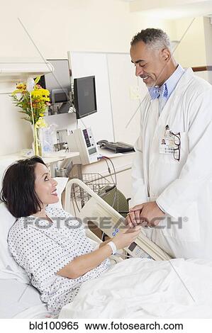 Stock Photography - Doctor comforting patient in hospital. Fotosearch