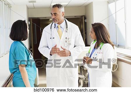 Stock Photograph - Doctors and nurse talking in hospital. Fotosearch