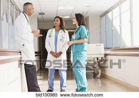 Stock Photography - Doctors and nurse talking in hospital. Fotosearch