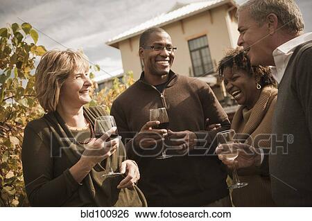 Friends drinking wine in vineyard View Large Photo Image Stock Photograph - Friends drinking wine in vineyard. Fotosearch