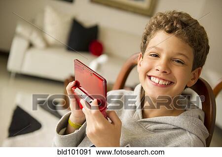 Hispanic boy playing video game View Large Photo Image Stock Image - Hispanic boy playing video game. Fotosearch
