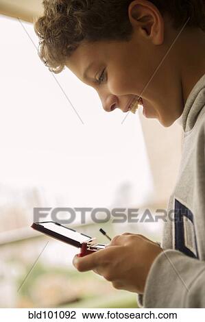Hispanic boy playing video game View Large Photo Image Stock Image - Hispanic boy playing video game. Fotosearch