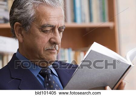 Hispanic businessman reading book View Large Photo Image Stock Photography - Hispanic businessman reading book. Fotosearch