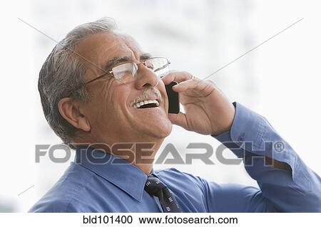 Stock Image - Hispanic businessman talking on cell phone. Fotosearch