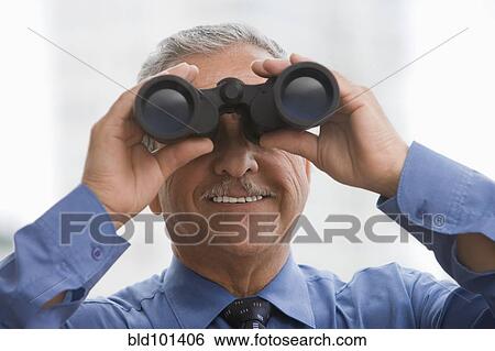 Stock Photograph - Hispanic businessman using binoculars. Fotosearch
