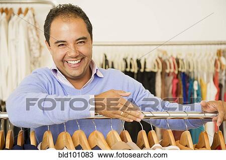 Hispanic man working in clothing store View Large Photo Image Stock Image - Hispanic man working in clothing store. Fotosearch