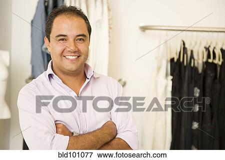 Hispanic man working in clothing store View Large Photo Image Stock Photo - Hispanic man working in clothing store. Fotosearch