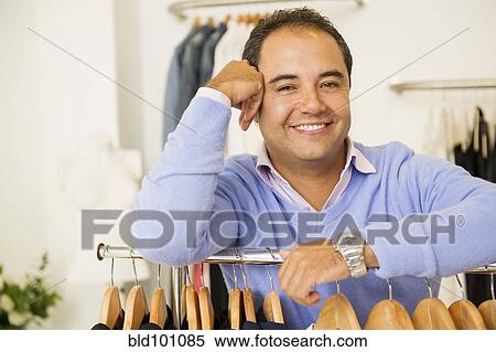 Hispanic man working in clothing store View Large Photo Image Stock Photography - Hispanic man working in clothing store. Fotosearch
