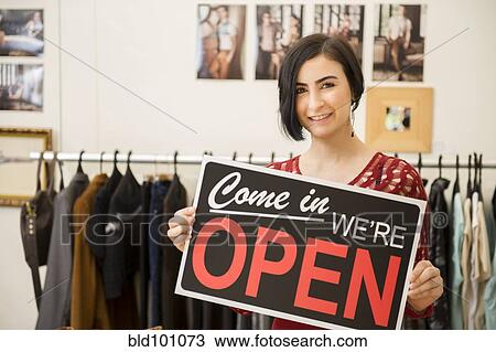 Hispanic woman holding open sign View Large Photo Image Stock Image - Hispanic woman holding open sign. Fotosearch