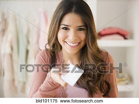 Stock Photography - Hispanic woman shopping with credit card. Fotosearch