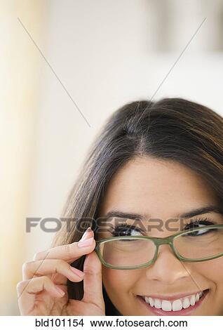 Picture - Hispanic woman wearing eyeglasses. Fotosearch