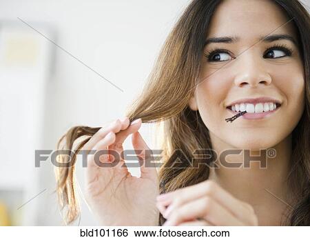 Hispanic woman with bobby pins in her mouth View Large Photo Image Stock Photograph - Hispanic woman with bobby pins in her mouth. Fotosearch