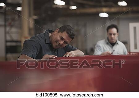 Stock Photography - Hispanic worker working in warehouse. Fotosearch