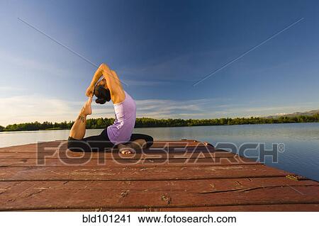 Korean woman practicing yoga on lake pier View Large Photo Image Stock Image - Korean woman practicing yoga on lake pier. Fotosearch