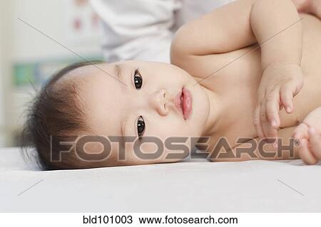 Mixed race baby laying in doctor's office View Large Photo Image Stock Image - Mixed race baby laying in doctor's office. Fotosearch