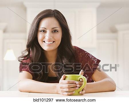 Stock Photo - Mixed race woman drinking coffee. Fotosearch