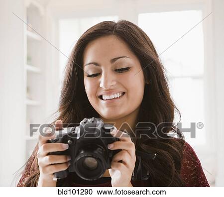 Stock Image - Mixed race woman looking at camera. Fotosearch