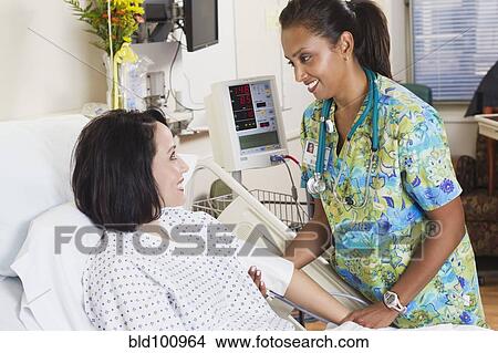 Picture - Nurse comforting patient in hospital. Fotosearch