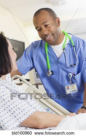Nurse comforting patient in hospital View Large Photo Image Stock Image - Nurse comforting patient in hospital. Fotosearch