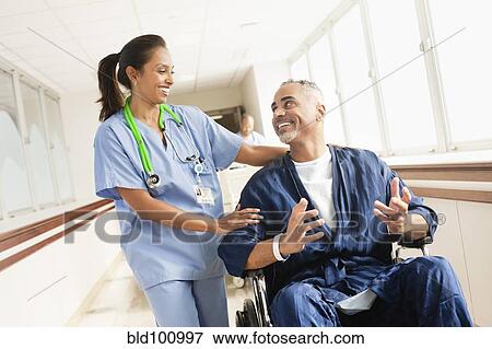 Nurse comforting patient in wheelchair in hospital View Large Photo Image Stock Photo - Nurse comforting patient in wheelchair in hospital. Fotosearch