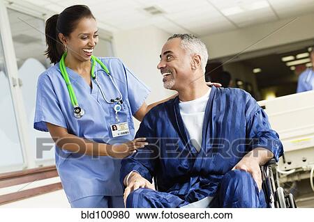 Nurse talking to patient in wheelchair in hospital View Large Photo Image Stock Image - Nurse talking to patient in wheelchair in hospital. Fotosearch