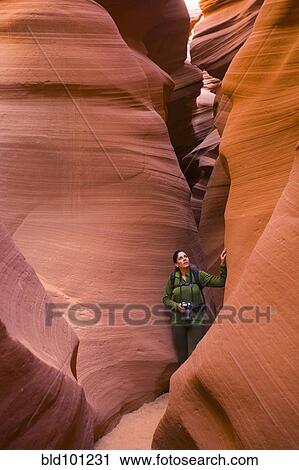 Stock Image - Persian woman hiking in canyon. Fotosearch