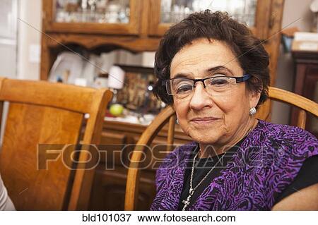 Senior Hispanic woman at dinner table View Large Photo Image Stock Photo - Senior Hispanic woman at dinner table. Fotosearch