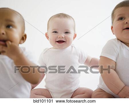 Smiling babies sitting together View Large Photo Image Stock Image - Smiling babies sitting together. Fotosearch