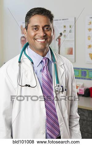 Stock Photo - Smiling Indian doctor in doctor's office. Fotosearch