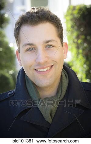 Smiling man in coat and scarf View Large Photo Image Stock Image - Smiling man in coat and scarf. Fotosearch