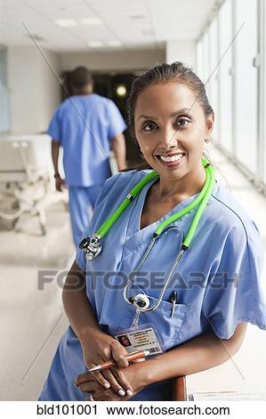 Smiling nurse leaning on window sill in hospital View Large Photo Image Stock Image - Smiling nurse leaning on window sill in hospital. Fotosearch