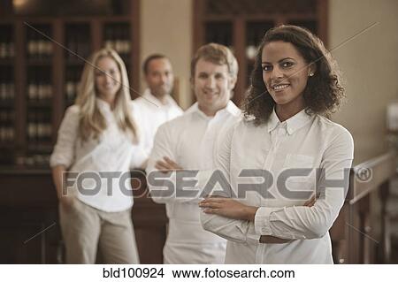 Picture - Wait staff standing in restaurant. Fotosearch