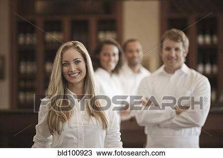 Wait staff standing in restaurant View Large Photo Image Stock Image - Wait staff standing in restaurant. Fotosearch