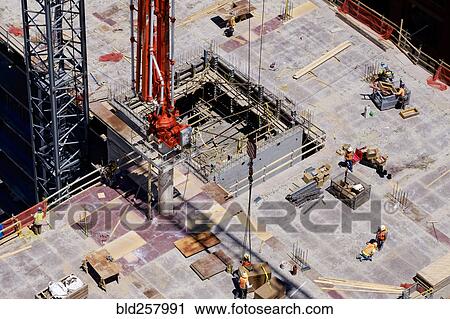 Stock Image - Aerial view of workers at construction site. Fotosearch