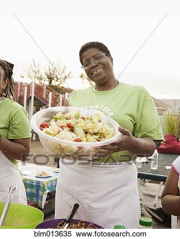 African American volunteer holding bowl of salad View Large Photo Image Stock Photography - African American volunteer holding bowl of salad. Fotosearch