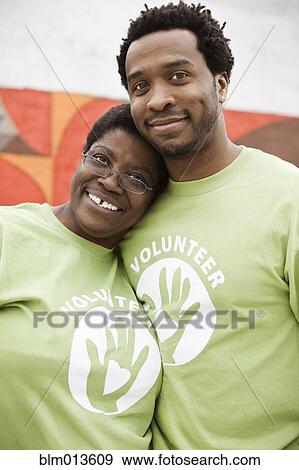 Stock Photo - African American volunteers hugging. Fotosearch