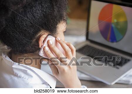 African American woman talking on cell phone and using laptop View Large Photo Image Stock Photo - African American woman talking on cell phone and using laptop. Fotosearch