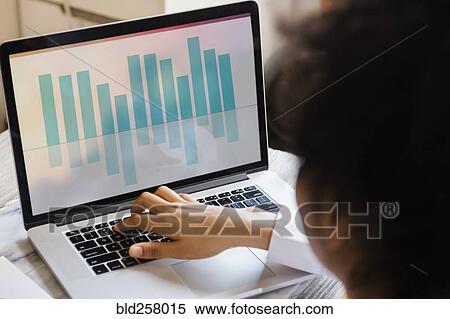 Stock Photography - African American woman typing on laptop. Fotosearch