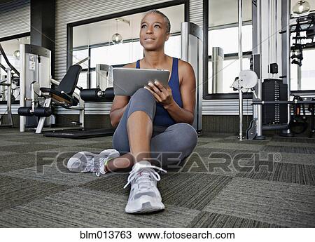 African American woman using digital tablet in health club View Large Photo Image Stock Image - African American woman using digital tablet in health club. Fotosearch