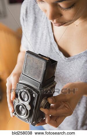 African American woman using old-fashioned camera View Large Photo Image Stock Photo - African American woman using old-fashioned camera. Fotosearch