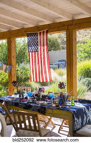 American flag hanging on patio near table View Large Photo Image Stock Image - American flag hanging on patio near table. Fotosearch