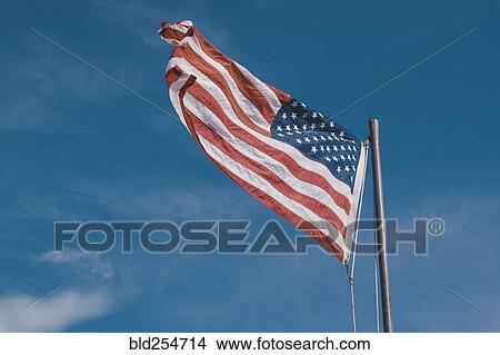 American flag under blue sky View Large Photo Image Picture - American flag under blue sky. Fotosearch